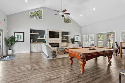 Resident clubhouse with billiards table and gathering space at Southwinds Point Apartments in Stockbridge, GA.