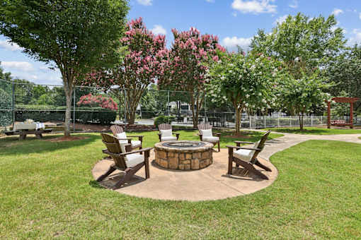 Outdoor fire pit and seating area at Southwinds Point Apartments, a pet-friendly community in Stockbridge, GA.