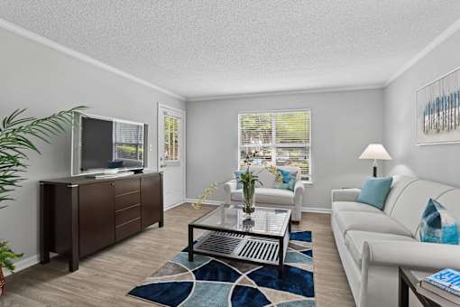 Open-concept living room with natural light at Southwinds Point Apartments near I-75 in Stockbridge, GA.