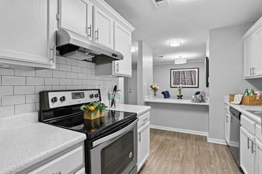 Updated apartment kitchen with ample cabinet space at Southwinds Point Apartments near Atlanta.
