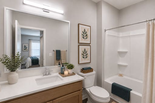Contemporary apartment bathroom with oversized vanity and tub-shower combination at Springview Apartments in Decatur, Georgia.