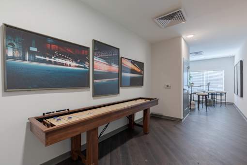 Resident game room with suffleboard table and lounge seating at Springview Apartments in Decatur near South DeKalb.