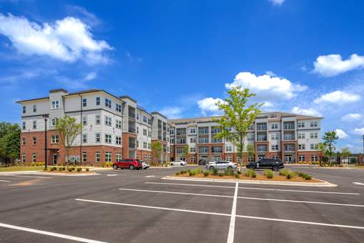 Exterior view of Springview Apartments featuring modern apartment homes and convenient parking near Panthersville Road in Decatur, Georgia.