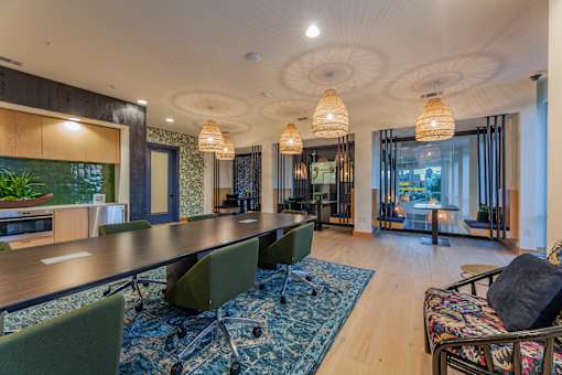 a room with a long table and chairs