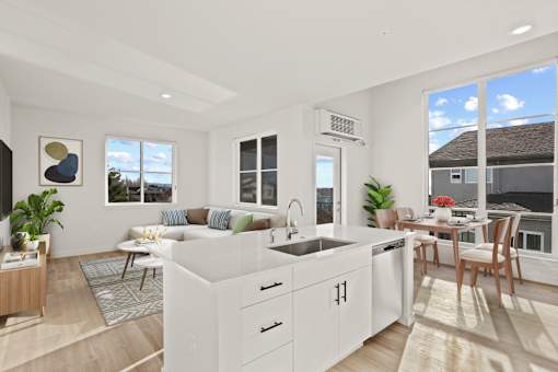 A modern kitchen with white cabinets and a large island.