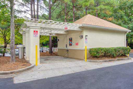 A small building with a yellow pole in front of it.