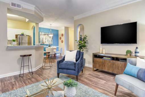 A living room with a blue chair and a black TV.