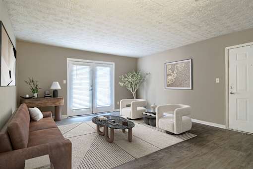 “Living room with large window door providing abundant natural light and access to outdoor space in a pet-friendly home at Stratford Ridge Apartments in Marietta, GA.