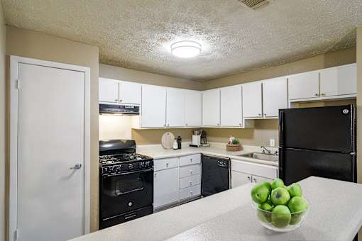 Kitchen with black appliances and gas range in Marietta apartment home