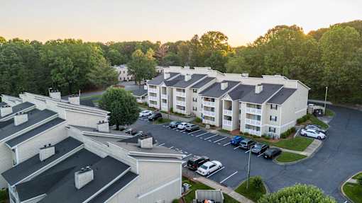 Sugar Creek Apartments Winston-Salem aerial photo showing apartment homes, parking, and wooded neighborhood setting