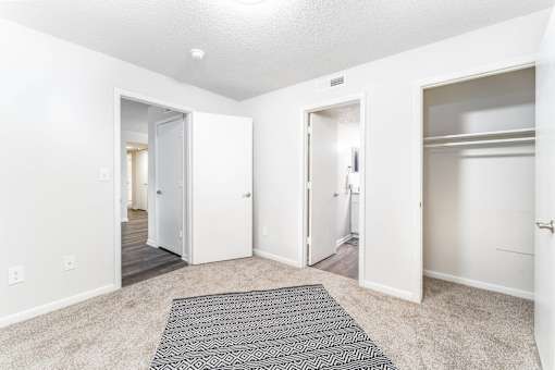 Unfurnished bedroom with en suite bathroom and closet at Sugar Creek Apartments Winston Salem NC
