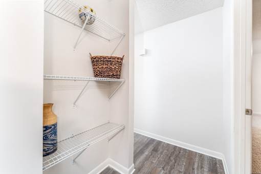 Apartment storage shelving area at Sugar Creek Apartments in Winston Salem NC with built in shelves and wood style flooring