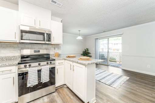 Winston Salem NC apartments for rent kitchen with granite counters stainless appliances and balcony at Sugar Creek Apartments