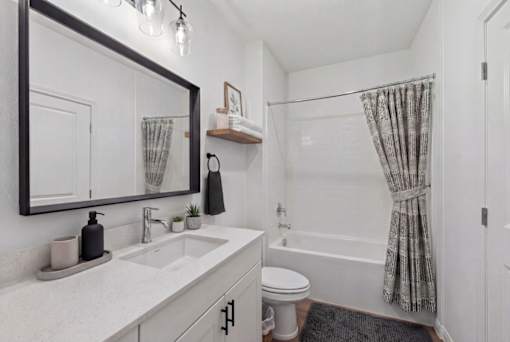 Sleek modern bathroom with elegant fixtures, chic vanity, and contemporary tile design.