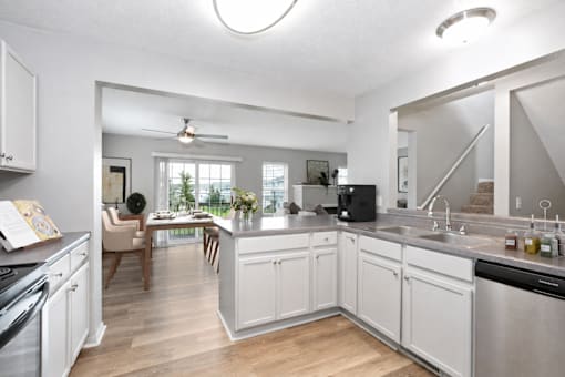 Kitchen at Summit Townhomes in Burnsville, MN, overlooking virtually staged dining and living areas.