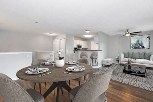 Virtually staged dining and living area at Summit Townhomes in Burnsville, MN, with breakfast bar seating.