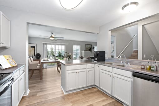 Pet-Friendly Townhomes in Burnsville, MN – Summit Townhomes - the view of a kitchen and living room with a large mirror