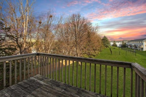 Pet-Friendly Townhomes in Burnsville, MN – Summit Townhomes - the view from the balcony of a home with a sunset