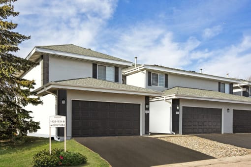 Burnsville, MN Townhomes – Summit Townhomes - house with a garage door and a sign in front of it