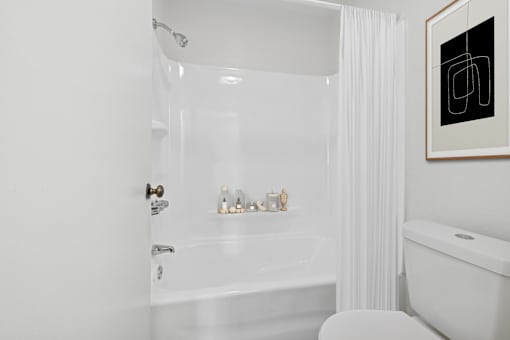 Bathroom with tub and shower combo at Sunnyside Senior Apartments San Dimas CA