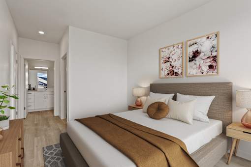 A bedroom with a large bed and a view of a balcony.