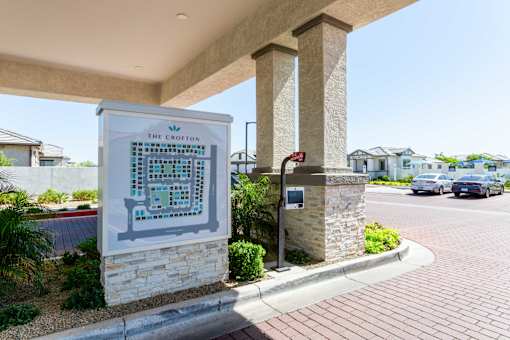 A sign for The Crofton is displayed in front of a building.