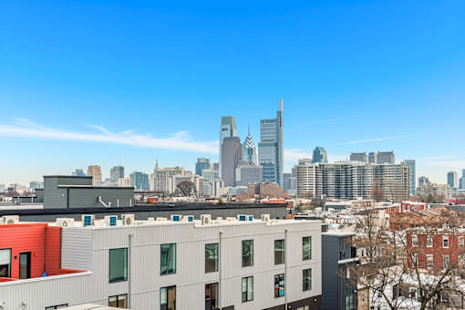 A cityscape with a mix of modern and traditional buildings under a clear blue sky.