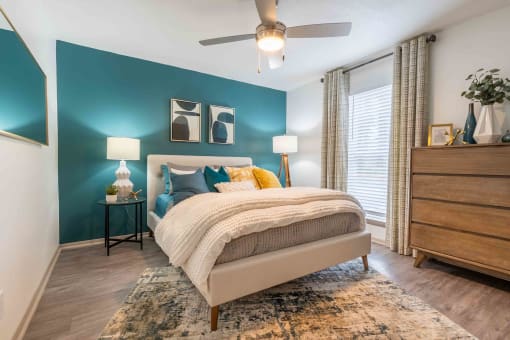 The Jaunt Apartments in Charleston South Carolina photo of a bedroom with a bed and a ceiling fan