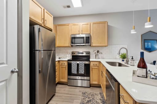 Sage at 1240 apartments in Mount Pleasant South Carolina photo of kitchen with oak cabinets and stainless steel appliances