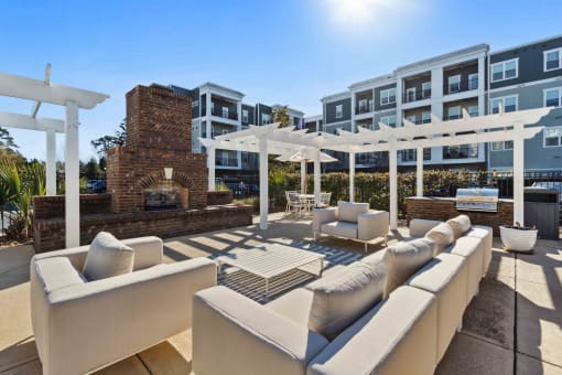 Sage at 1240 apartments in Mount Pleasant South Carolina photo of sundeck with outdoor seating, fireplace and grills
