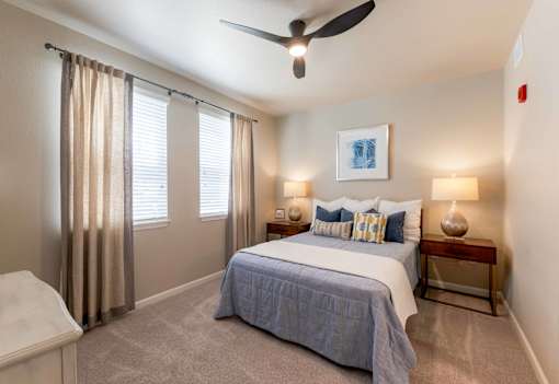 Cozy bedroom featuring a ceiling fan and large windows at The Sanctuary at 331 in Santa Rosa Beach, FL