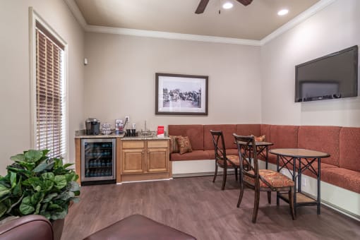 a room with a couch and a table and chairs