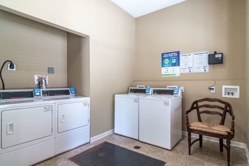 Pet-Friendly Apartments in Opelika, AL – The Crossings of Opelika - a laundry room with washers and dryers