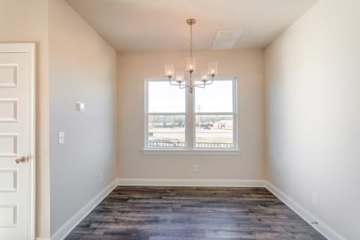 3-Bedroom Townhomes in Gallatin, TN - The Gardens at Preston Park - Dining Nook with Vinyl Plank Flooring, Chandelier, and Window.