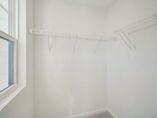 Walk-in closet with built-in shelving at The Maple Raleigh NC townhomes for rent