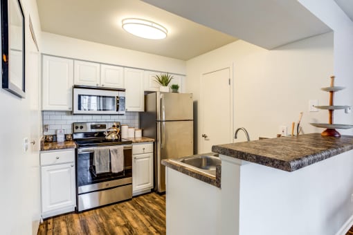 Apartments in Glendale Heights for rent - The Mark - kitchen with stainless steel appliances and a quartz counter top