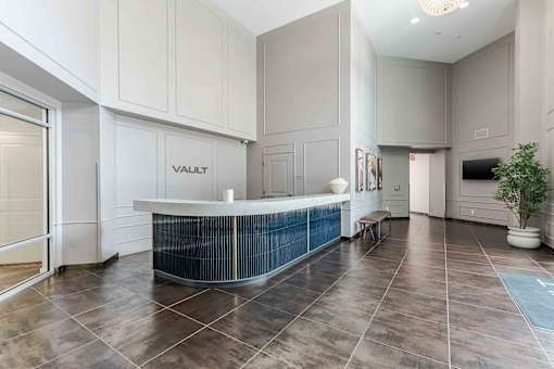A reception area with a Vault sign on the wall.