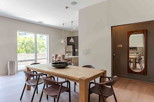 A dining room with a wooden table and chairs.