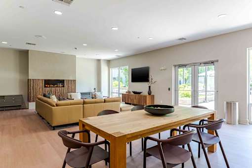 A modern dining room with a wooden table and chairs.
