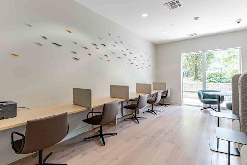 A conference room with a long table and chairs.