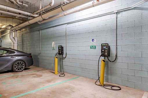 A charging station for electric vehicles is located in a parking garage.