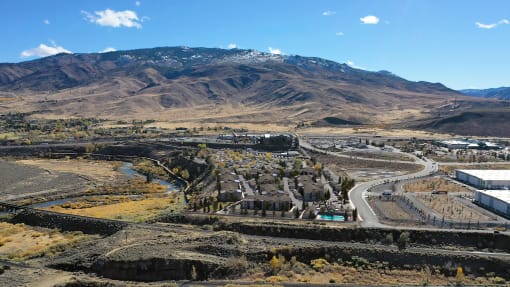 an aerial view of a city with mountains in the background