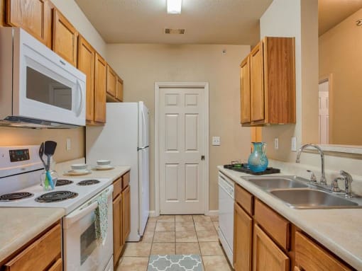 Clarksville, TN Apartments - Parc at Clarksville - Photo of Kitchen with storage space and white appliances