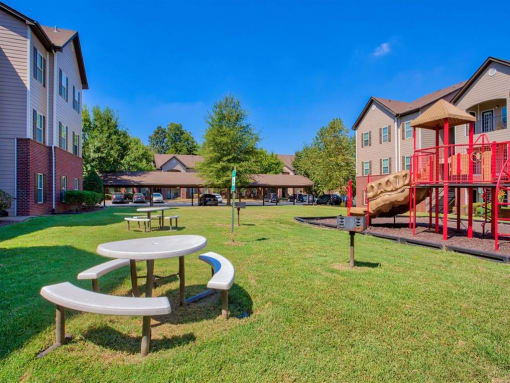 Clarksville, TN Apartments - Parc at Clarksville - Picnic Area and Playground in a grass area