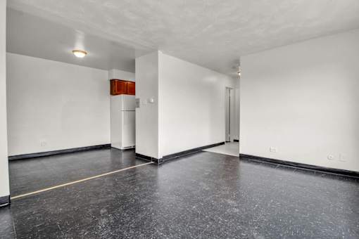 A room with a white wall and a red object on it.