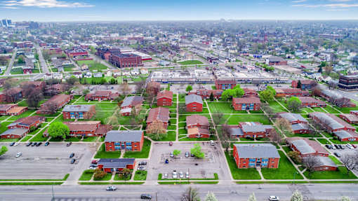 A large red building is in the center of a green field.