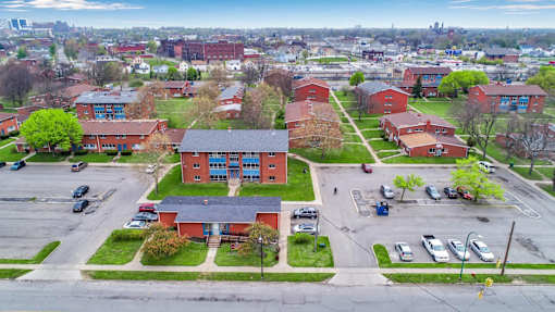 A parking lot with cars and a building in the background.