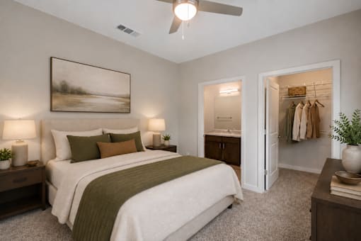Professionally staged bedroom with walk-in closet at Townes at Clarkston Centre apartments in Clarkston, GA.