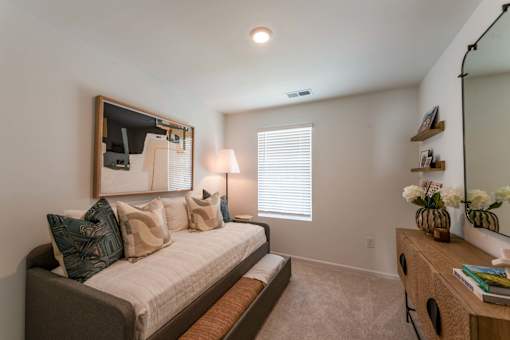 Additional bedroom with carpet flooring, window blinds, neutral finishes, and flexible guest room space at Townes at Olde Birch in Raleigh, NC.