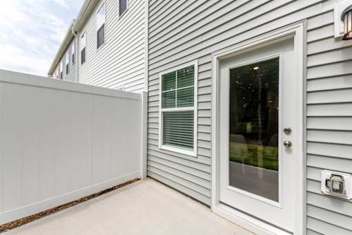 Private fenced patio with glass entry door at Townes at Olde Birch townhomes in Raleigh, NC.